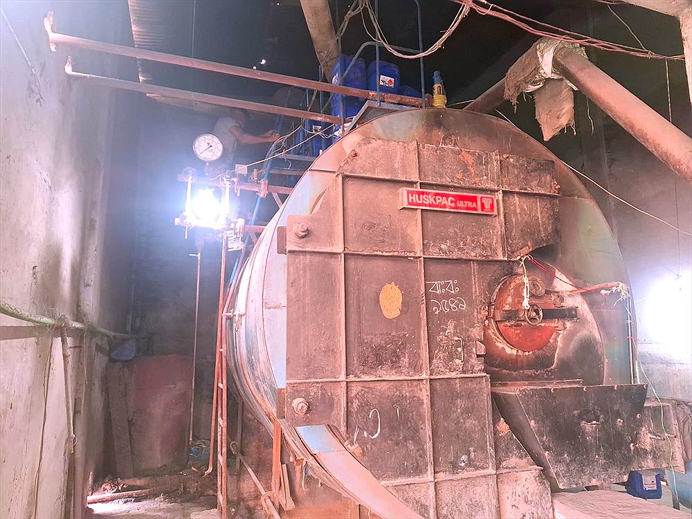 Husk-fired boiler at a parboiling rice mill